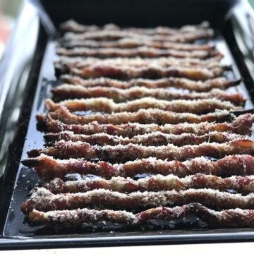 bacon wrapped bread sticks on pan