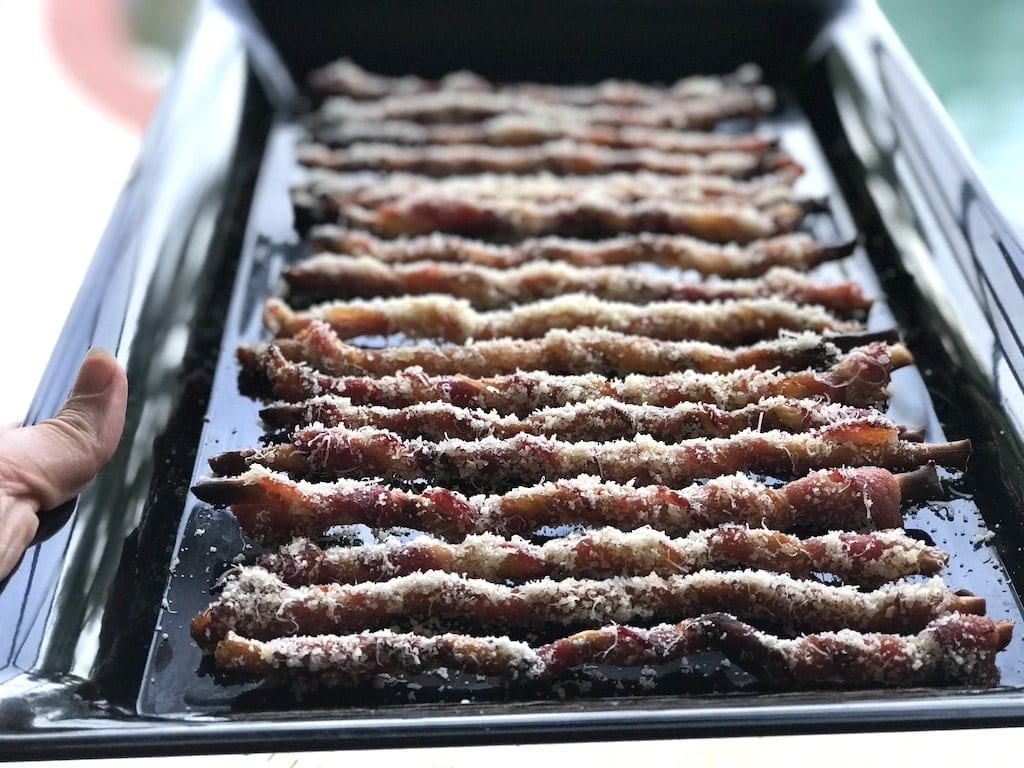 bacon wrapped bread sticks on pan