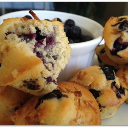 blueberry muffins with a bowl of blueberries