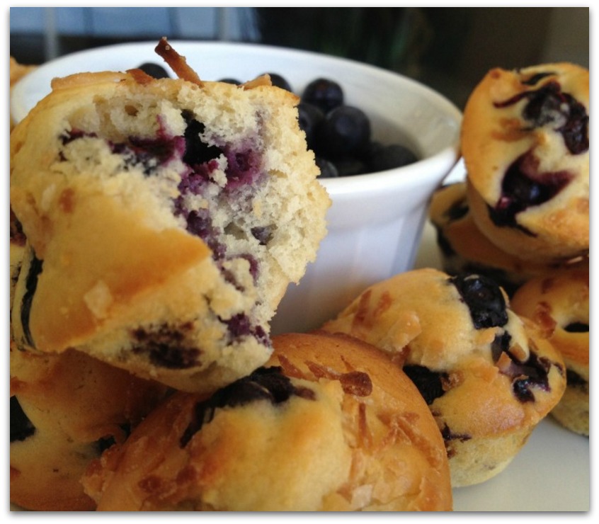 blueberry muffins with a bowl of blueberries