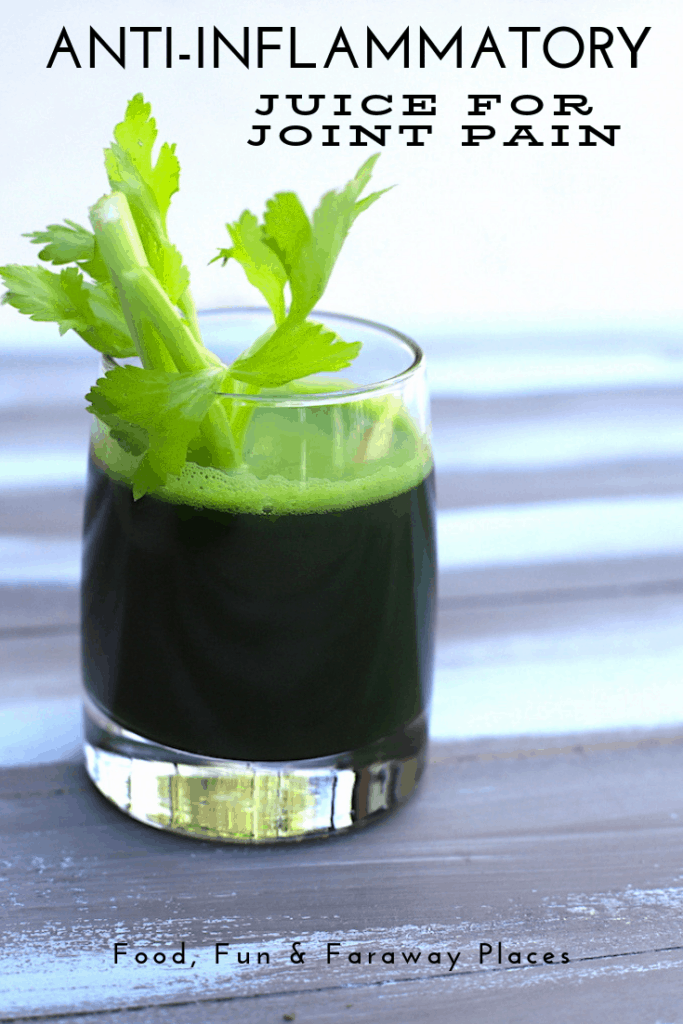 Glass of green juice with celery sticking out.