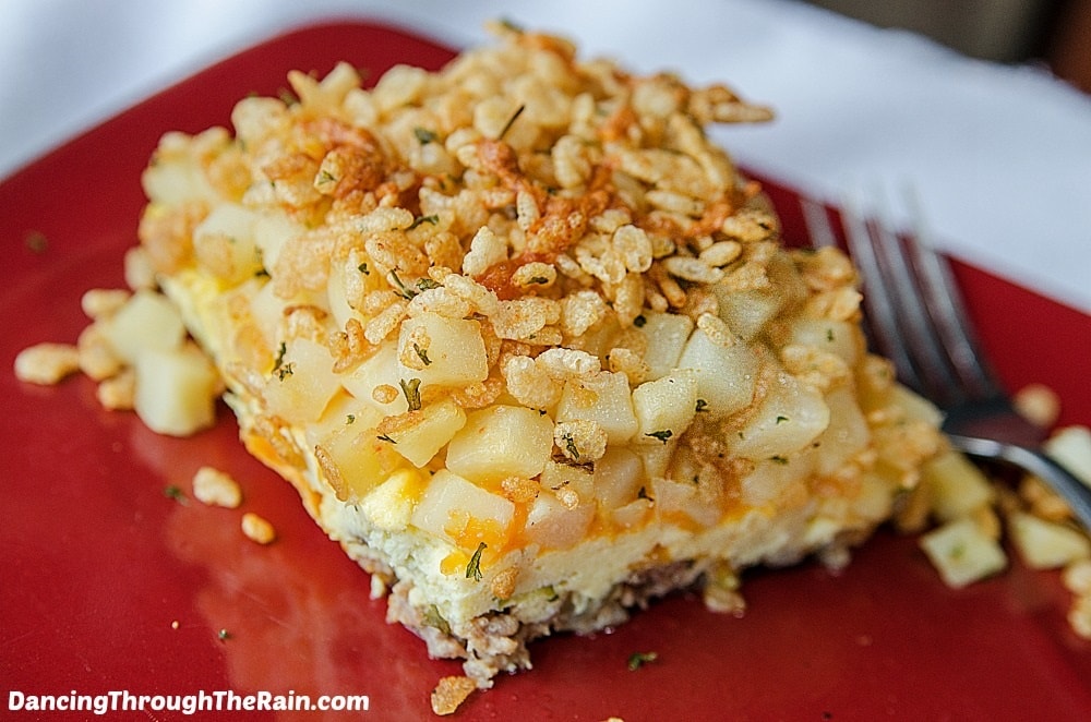 Hashbrown casserole on a red plate.