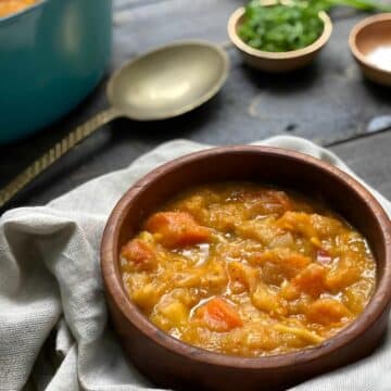 Wooden bowl with creamy vegetable soup.