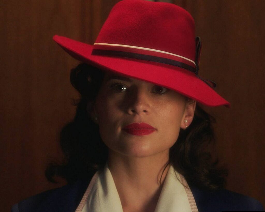 The Hat. Gigi Melton is the designer behind the fabulous fashion on Agent Carter. Here she holds an idea board showing how she comes up with ideas for what Hayley Atwell and the rest of the cast will wear. This is the gold dress worn by Hayley Atwell in Agent Carter.