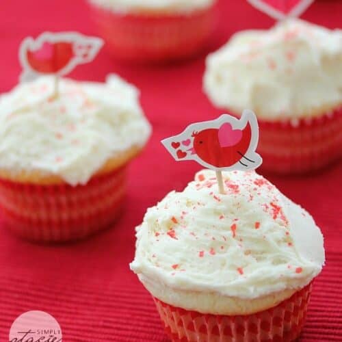 Cupcakes with white icing and red sprinkles.