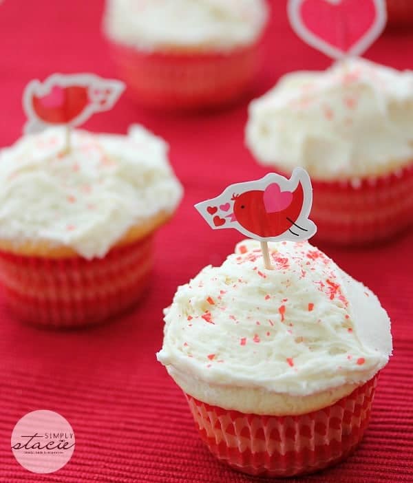 Cupcakes with white icing and red sprinkles.