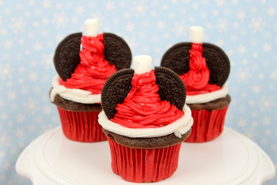 santa hat cupcakes, red, and white with a cookie on top