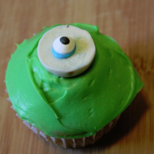 green cupcake with eyeball candy on top