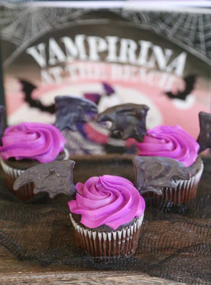 Bat wing cupcakes with purple icing.
