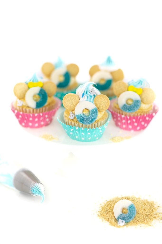 vanilla cupcakes with lifesavers and cookies on top