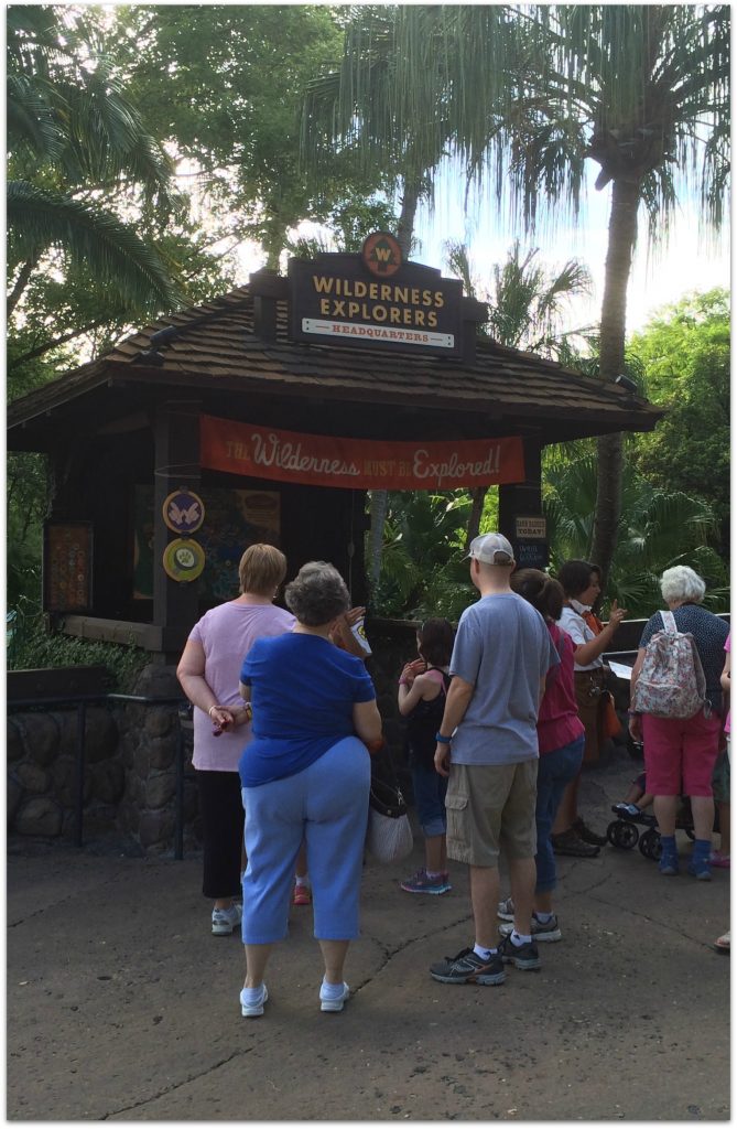 People asking questions at Wilderness Explorer booth at Animal Kingdom.