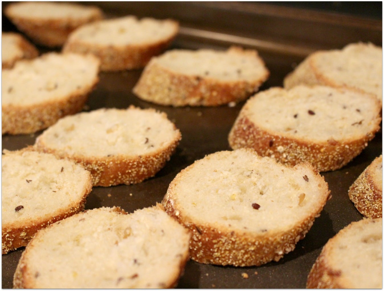 Sliced bread on baking sheet.