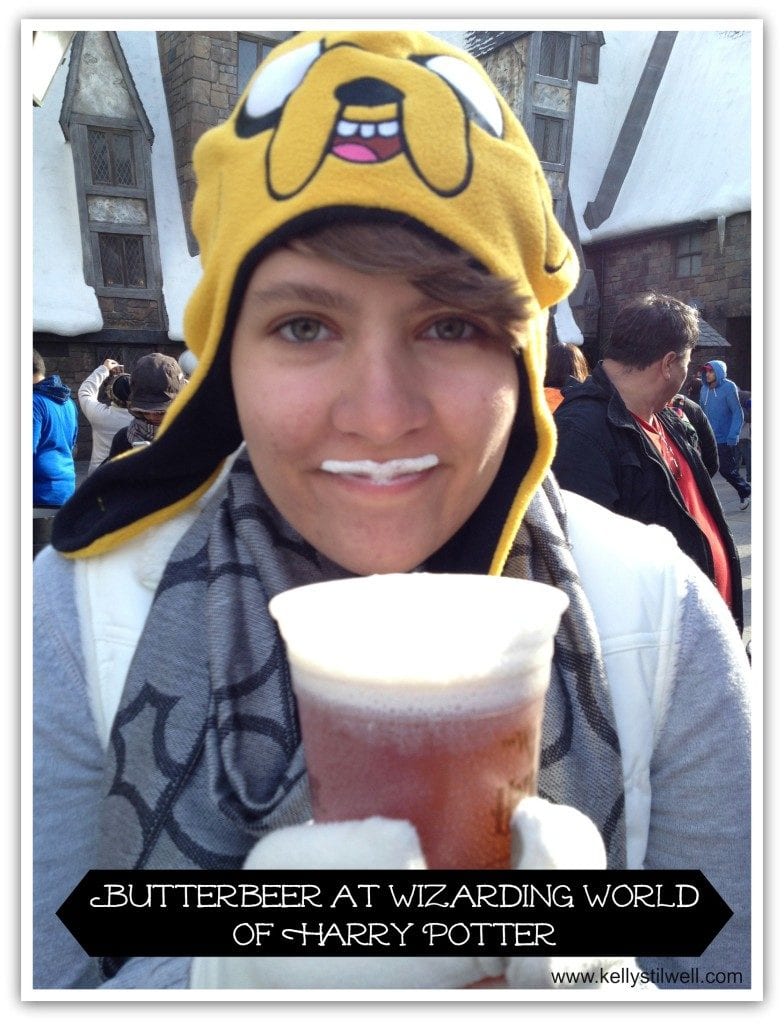 Girl drinking butter beer at Harry Potter World.