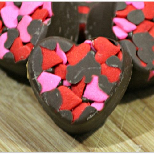 Chocolate candy truffles in heart shape.