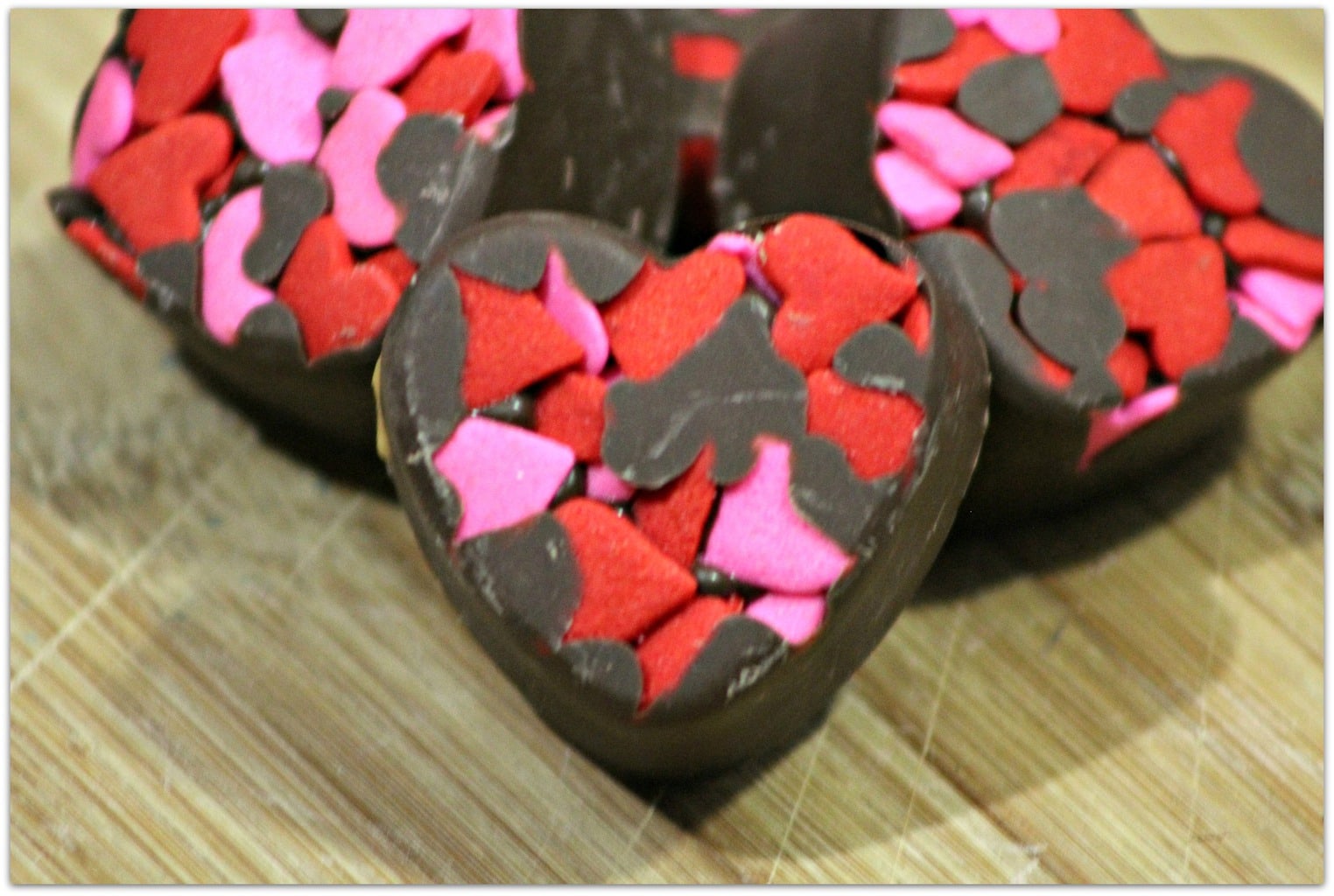 Chocolate candy truffles in heart shape.