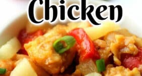 Chicken pieces with pineapple, red peppers, and sauce.