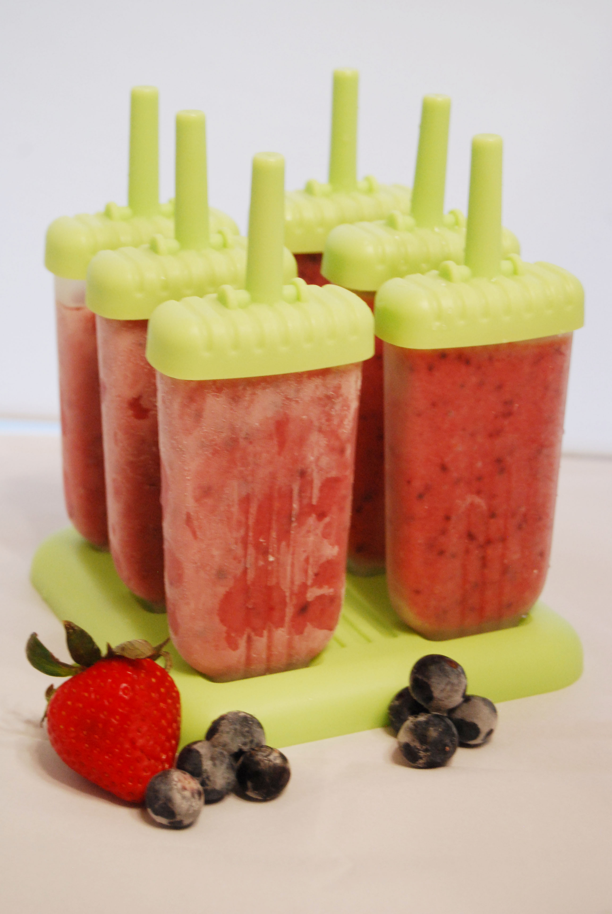 These Healthy Strawberry Apple Ice Pops are the perfect treat any time of day! This recipe is made with only fruit and no added sugar, and is a healthier alternative to Popsicles and ice cream, perfect for those of us who are trying to trim down for summer swim suits! Strawberries and apples are a yummy combination for this delicious treat, and instead of sugar, we've just added more fruit! This easy recipe will have you in and out of the kitchen in minutes, and you will love the flavor of this icy treat!