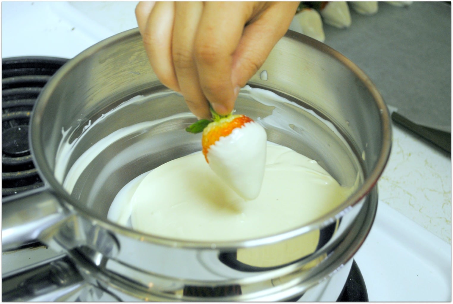 dipping strawberry in white chocolate