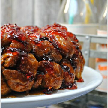 What could be better than a Peanut Butter and Jelly sandwich? Peanut Butter and Jelly Monkey Bread! The deliciousness of Monkey Bread combined with the homey flavors of PB & J is just fantastic, and it's so easy to make! Head to the kitchen with the kids and whip up this amazing dessert today! Your kids will love it! Take this to a party and be the rockstar guest!