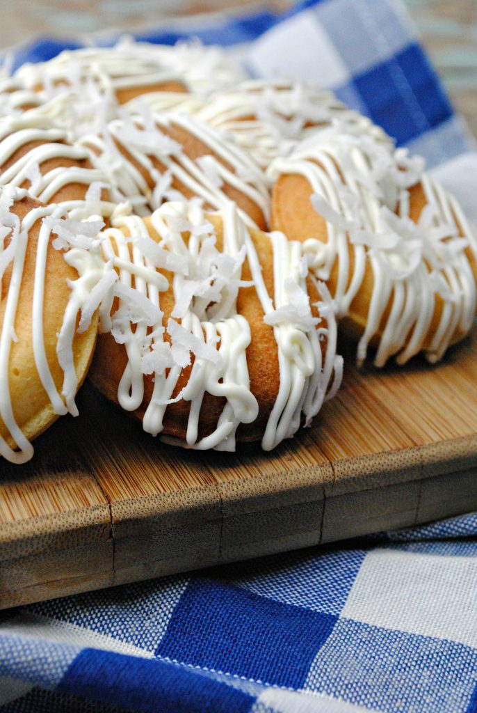 Doughnuts with crazy flavors are all the rage, and these Pineapple Doughnuts are the perfect easy recipe for a lazy weekend! Made with real pineapple and coconut, your family will love the tropical flavors.