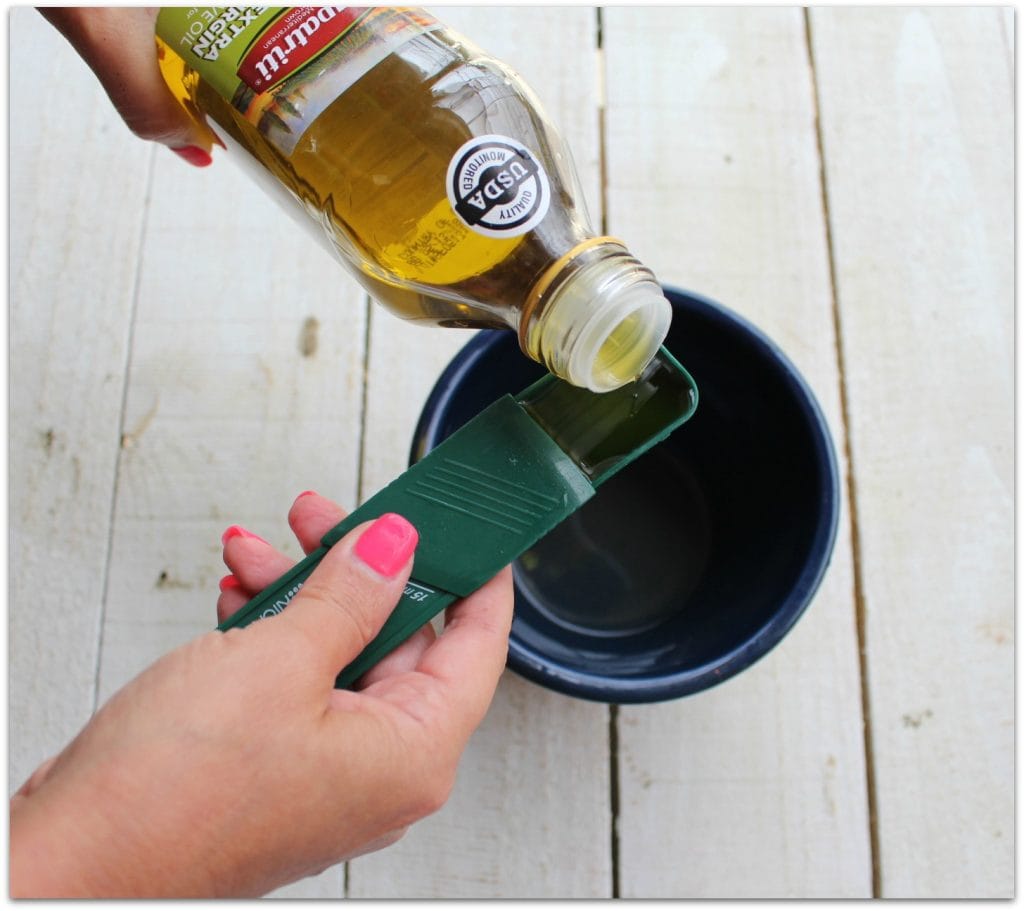 Pouring olive oil into a bowl.
