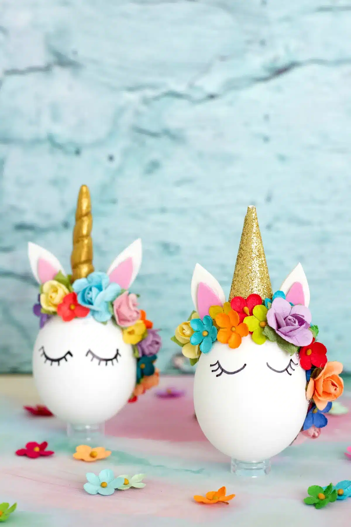 Two white eggs decorated like unicorns.