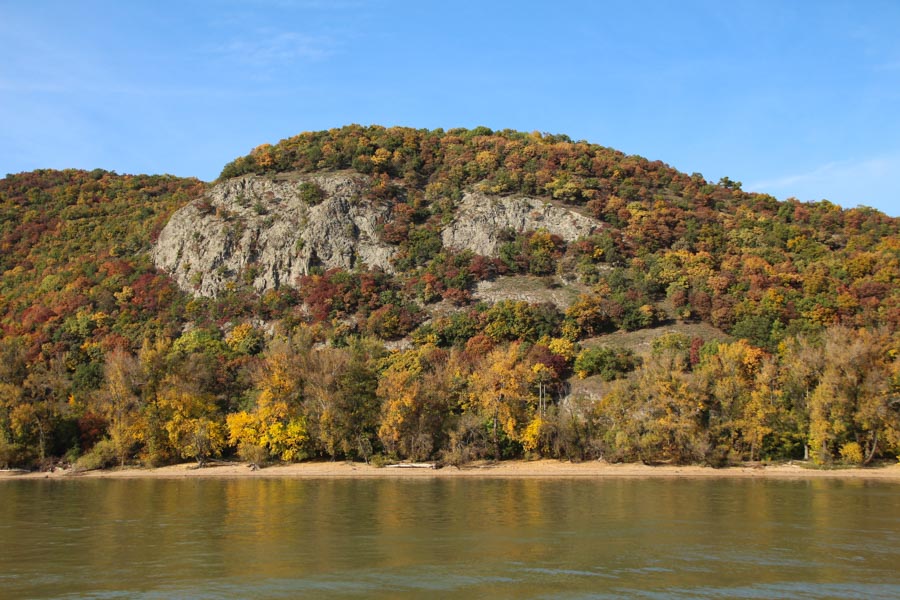 Fall colors on trees across river.