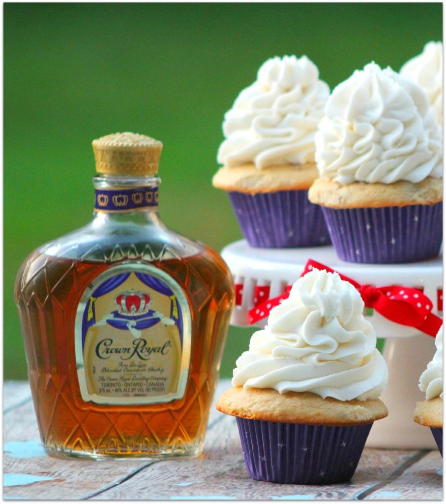 Cupcakes with white icing and a bottle of whisky.