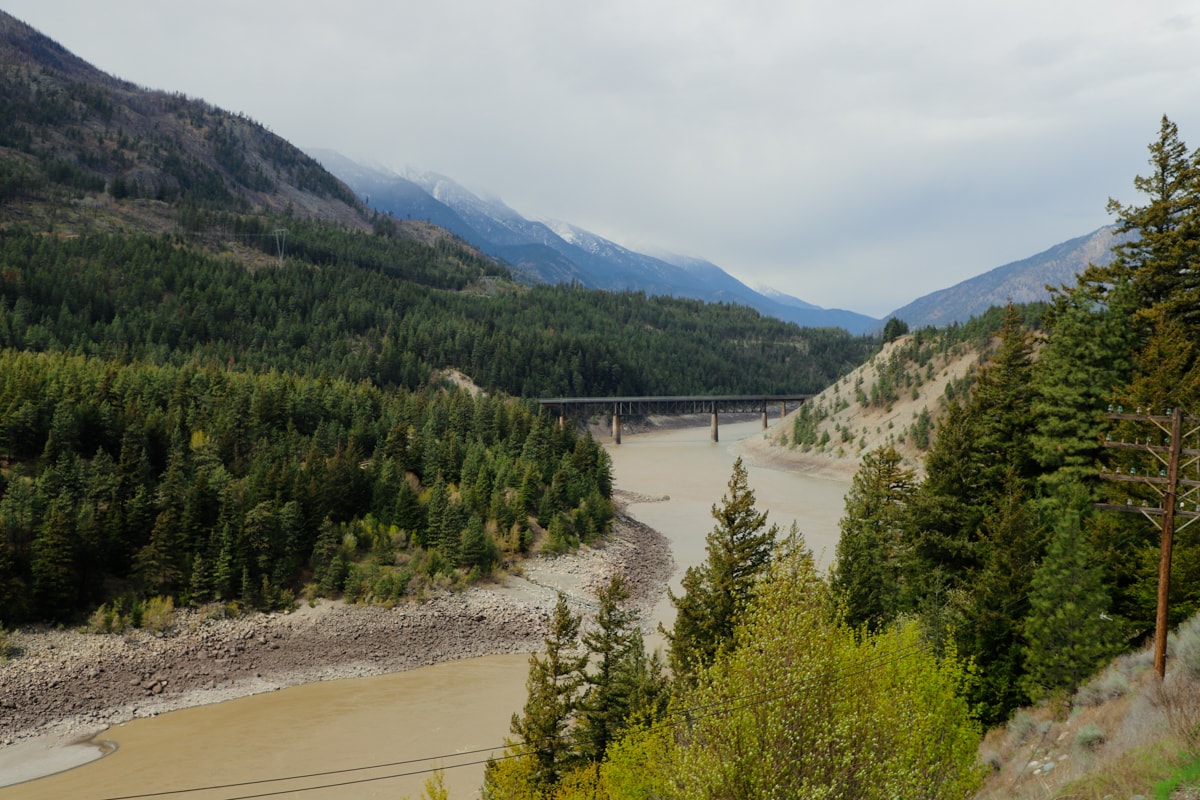 View of bridge in distance over river on Rocky Mountaineer Train.