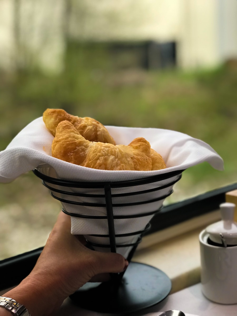 Basket of croissants in window of Rocky Mountaineer Train.