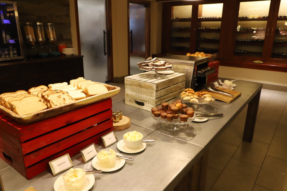 Breakfast buffet with breads and muffins.