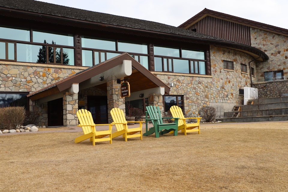 Adirondack chairs in front of hotel.