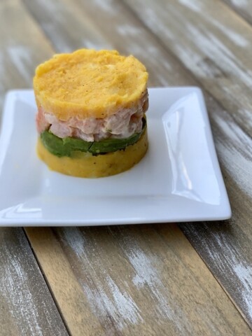 The Shrimp Causa I had on a food tour in Lima Peru last year was incredible. Have you ever eaten Peruvian food? #PeruvianFood #ShrimpRecipes #GAdventures