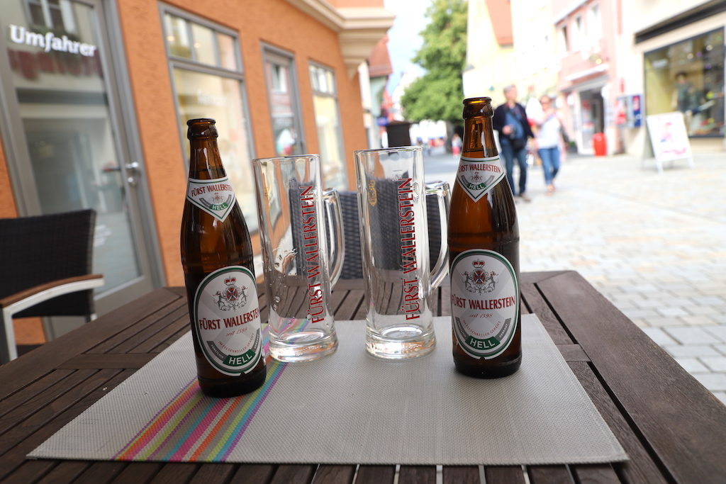 German beer in bottles on table with glasses.