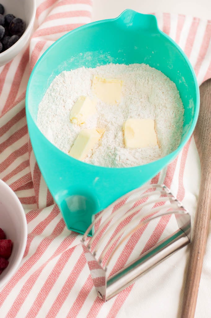 flour and butter in turquoise bowl on red and white tablecloth