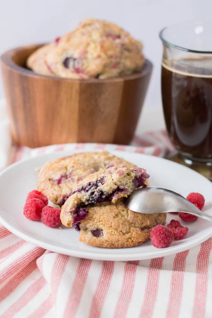 Mixed berry scones on white plate on red and white striped tablecloth