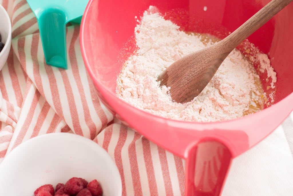 pink bowl of batter on red and white tablecloth