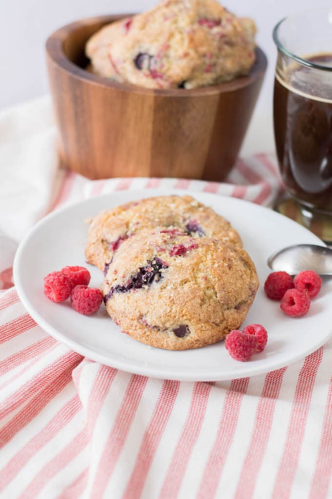 Mixed berry scones on white plate on red and white striped tablecloth