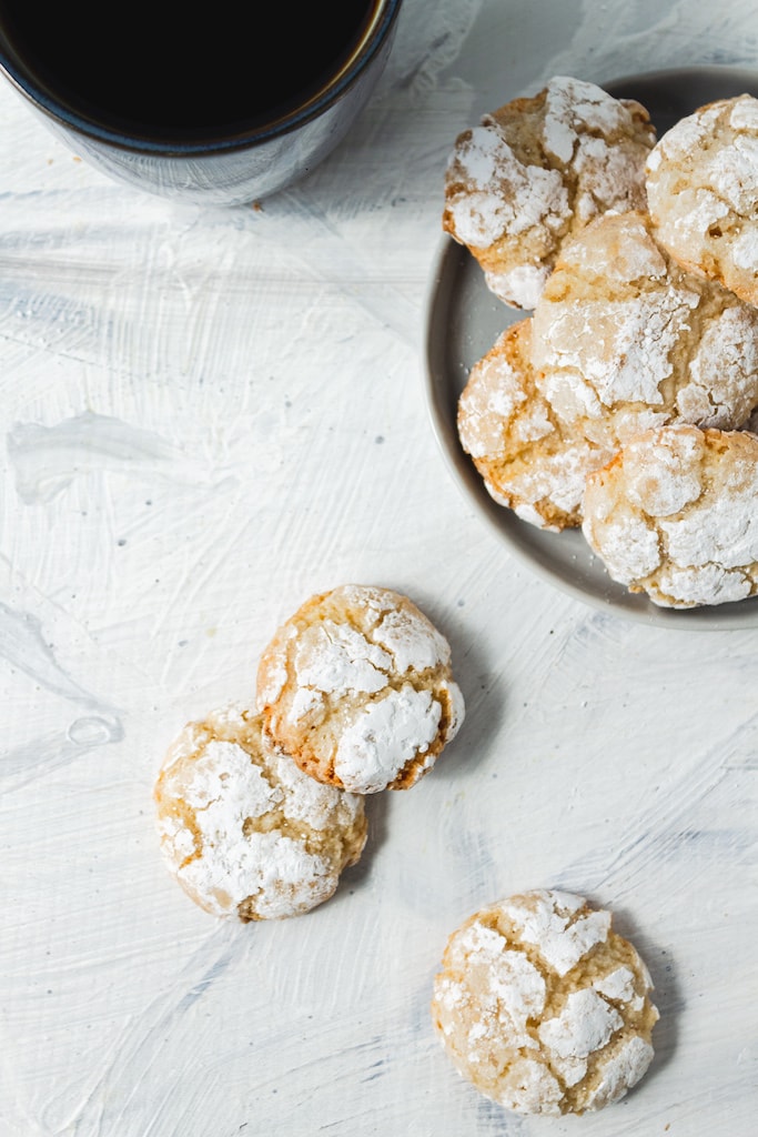 Amaretti cookies on marble counter and on plate in background 