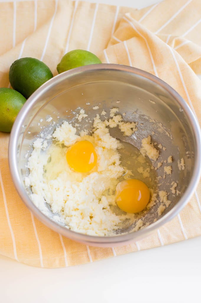 sugar, butter, eggs in bowl with limes on side