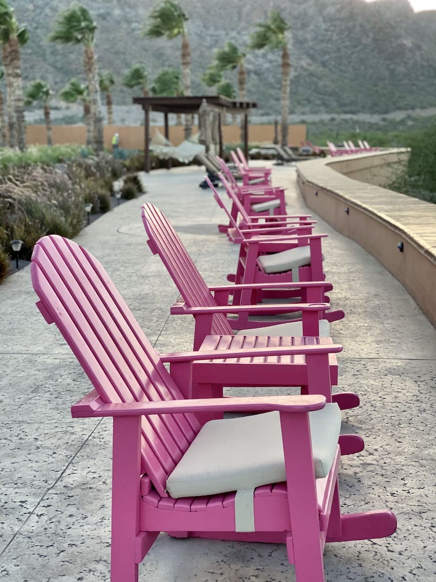 pink chairs facing beach