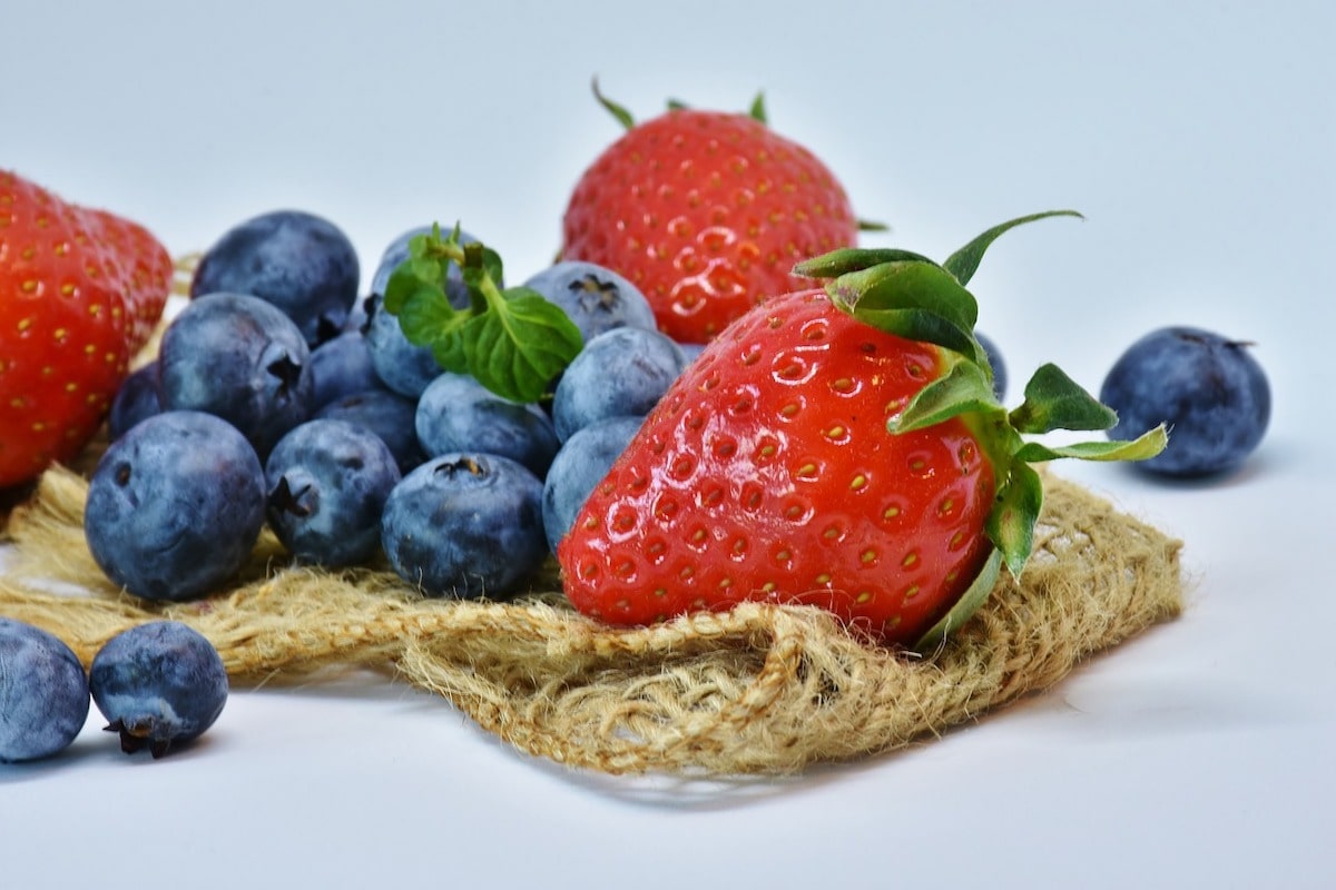 strawberries and blueberries on burlap