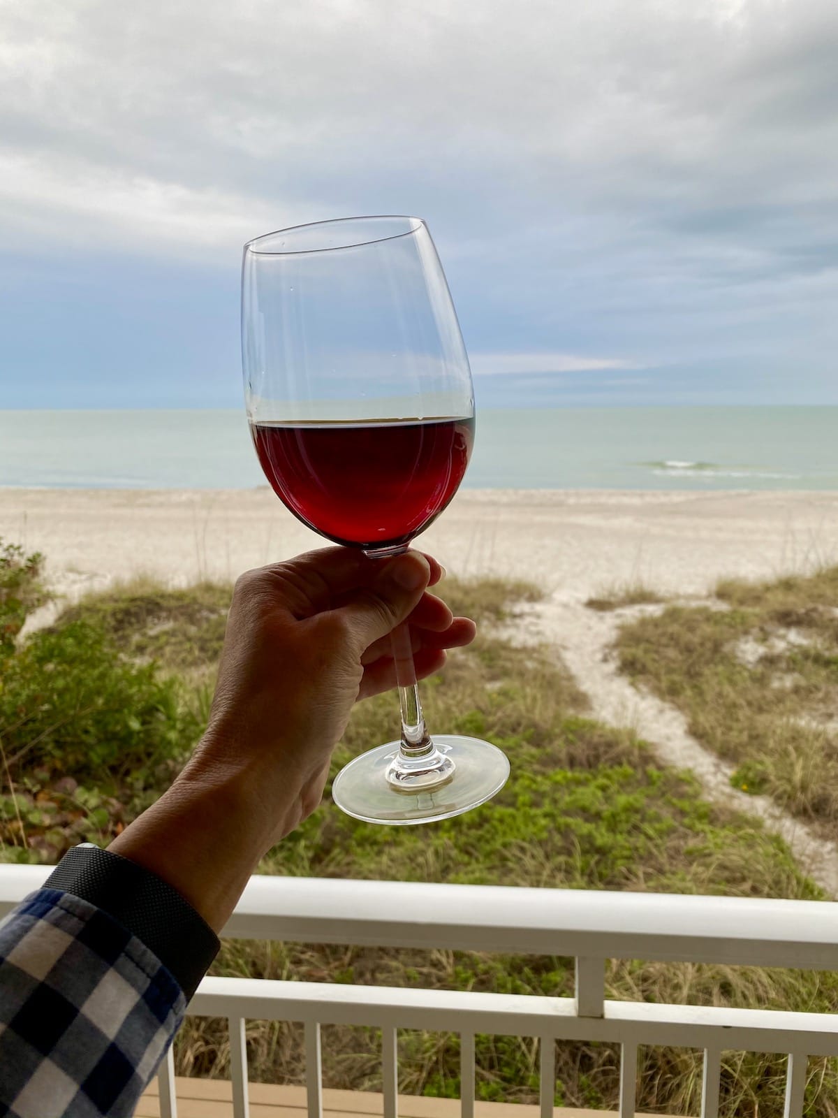 Toasting with wine on the balcony at Mainsail Beach Inn.