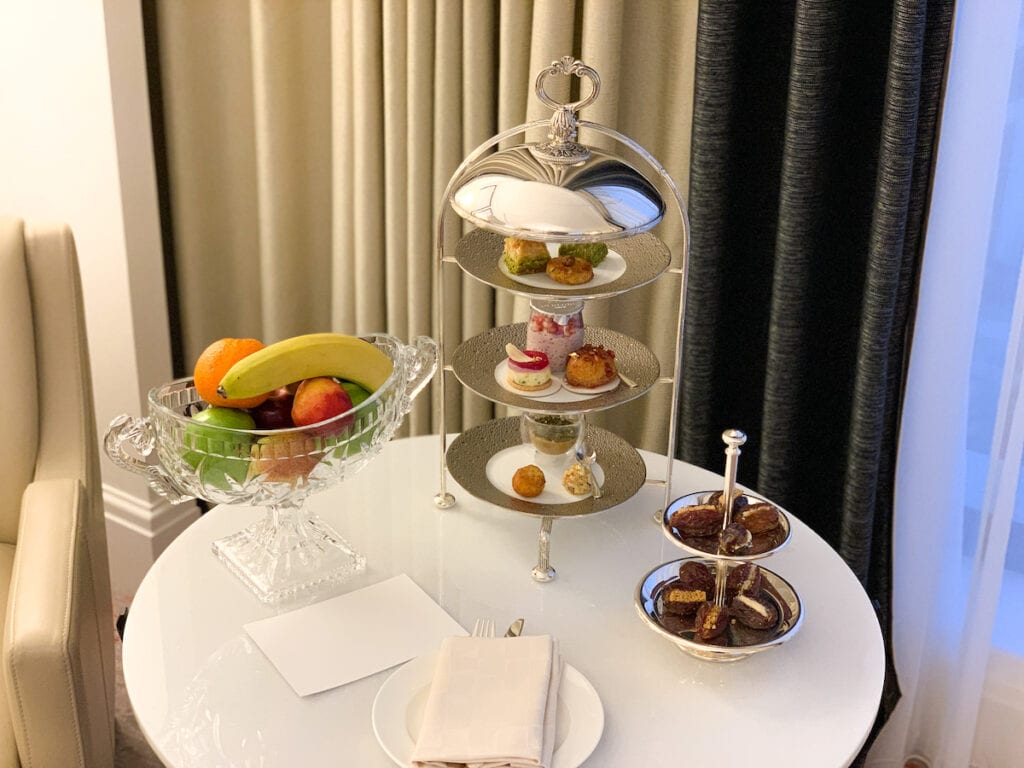 Round table with date desserts and fruit.