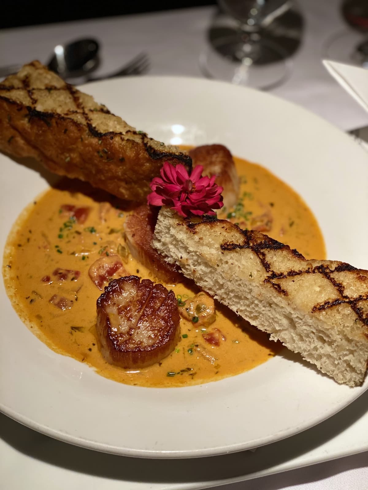 Scallops in a tomato broth with slices of grilled bread