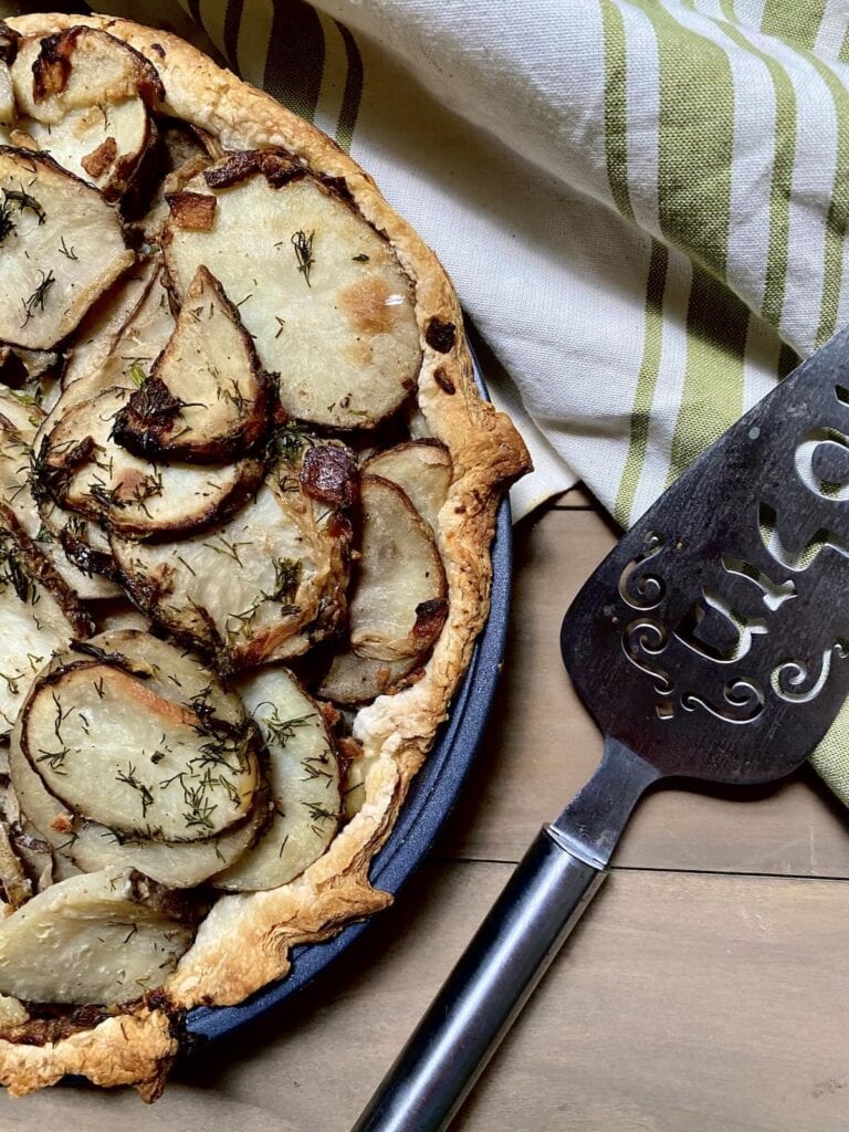 Irish Potato Pie in pan with pie spatula.