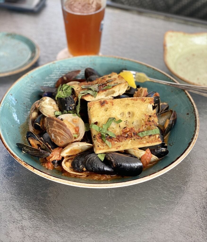 Mussels in a blue bowl on a table at The Waterfront.