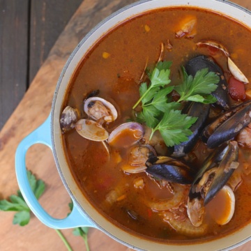 Cioppino with clams and mussels is a fish stew in a tomato broth.