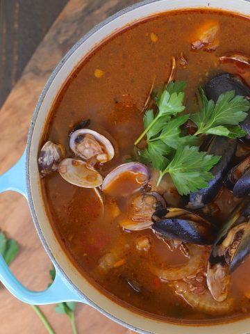 Cioppino with clams and mussels is a fish stew in a tomato broth.