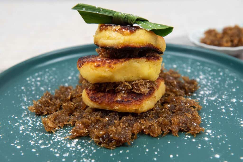 Layers of dessert with pandan leaf on top, called colenak in Indonesian desserts.